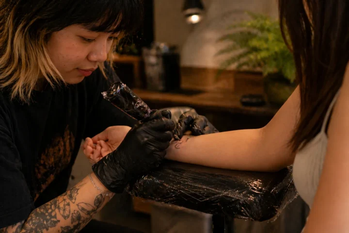 Mini tattoo Ho Chi Minh artist inking a tiny design on a wrist