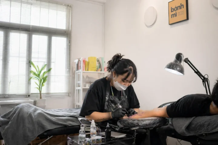 Inside a premium tattoo studio Ho Chi Minh City with artist at work